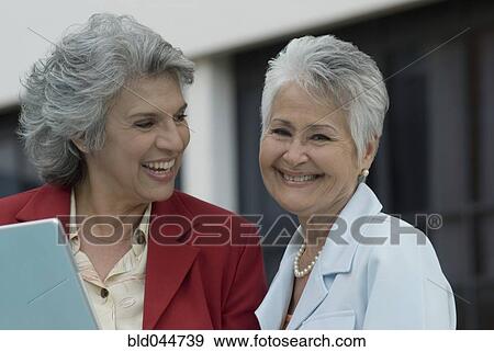 Stock Photo - Senior Hispanic women laughing. Fotosearch
