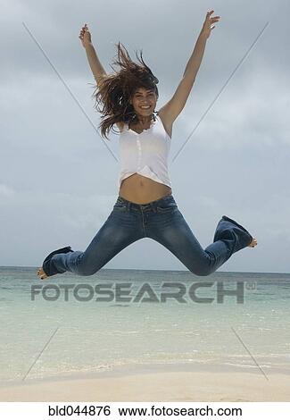 Woman jumping at beach View Large Photo Image Stock Photograph - Woman jumping at beach. Fotosearch