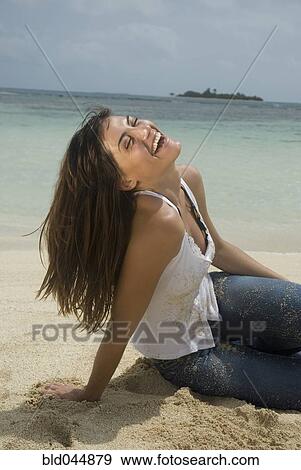 Stock Photo - Woman laughing at beach. Fotosearch