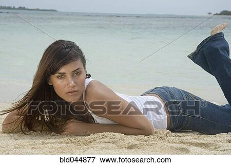 Woman laying on beach View Large Photo Image Stock Photo - Woman laying on beach. Fotosearch