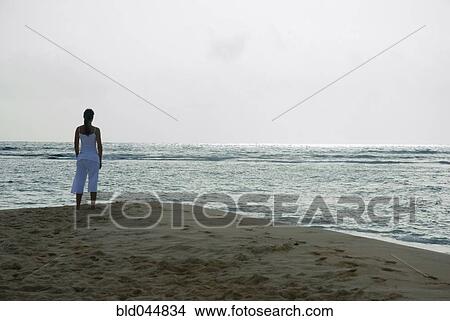Woman looking out over ocean View Large Photo Image Picture - Woman looking out over ocean. Fotosearch
