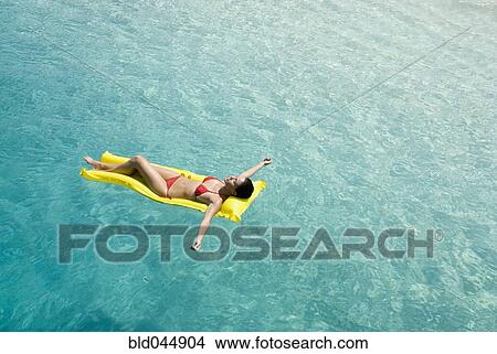 Woman on float in water View Large Photo Image Picture - Woman on float in water. Fotosearch