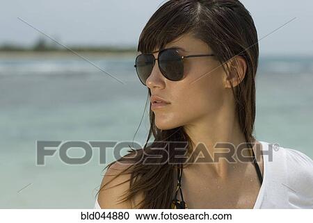 Stock Image - Woman wearing sunglasses. Fotosearch