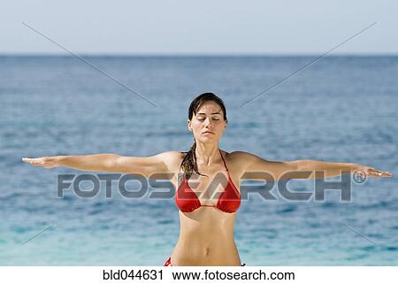 Young woman practicing yoga at beach View Large Photo Image Stock Image - Young woman practicing yoga at beach. Fotosearch