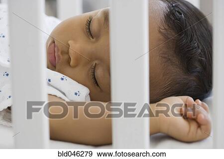 African American baby sleeping in crib View Large Photo Image Stock Photo - African American baby sleeping in crib. Fotosearch