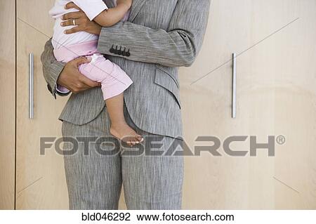 African American businesswoman holding baby View Large Photo Image Stock Image - African American businesswoman holding baby. Fotosearch