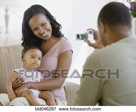 African American father taking photograph of family View Large Photo Image Stock Photo - African American father taking photograph of family. Fotosearch