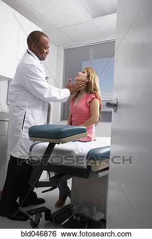 African American male doctor examining patient View Large Photo Image Stock Photograph - African American male doctor examining patient. Fotosearch