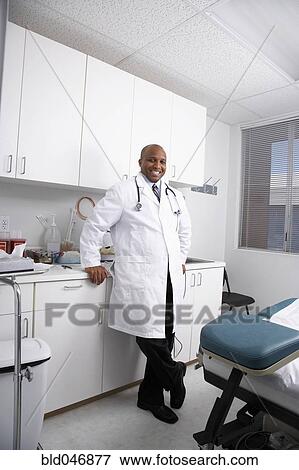 Stock Photo - African American male doctor in examining room. Fotosearch