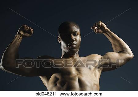 Stock Image - African American man flexing muscles. Fotosearch
