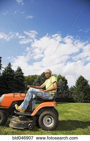 African American man mowing lawn Stock Photo | bld046907 | Fotosearch