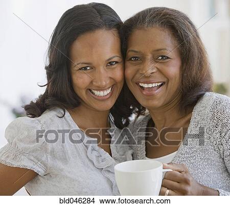 African American mother and adult daughter hugging View Large Photo Image Picture - African American mother and adult daughter hugging. Fotosearch
