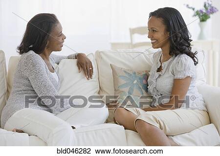 Stock Image - African American mother and adult daughter talking. Fotosearch