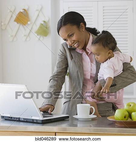 African American mother working at holding baby View Large Photo Image Stock Photo - African American mother working at holding baby. Fotosearch