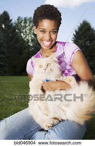 African American woman holding cat View Large Photo Image Picture - African American woman holding cat. Fotosearch