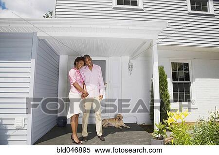 African couple and dog in front of house View Large Photo Image Stock Photography - African couple and dog in front of house. Fotosearch