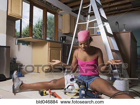 African woman shrugging shoulders at power tools View Large Photo Image Picture - African woman shrugging shoulders at power tools. Fotosearch