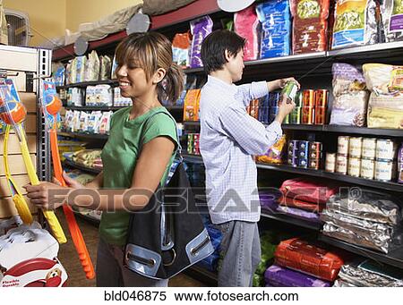 Stock Photography - Asian couple shopping in pet store. Fotosearch
