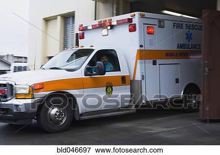 Stock Photo - Asian male paramedic driving ambulance. Fotosearch