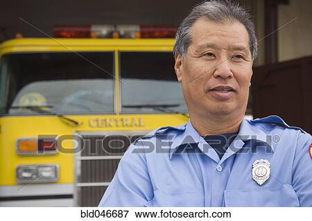 Asian male paramedic in front of ambulance View Large Photo Image Stock Photo - Asian male paramedic in front of ambulance. Fotosearch