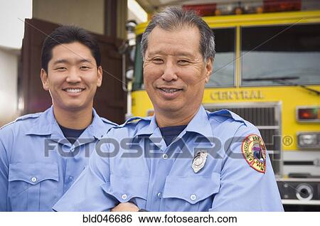 Asian male paramedics in front of ambulance View Large Photo Image Stock Photograph - Asian male paramedics in front of ambulance. Fotosearch