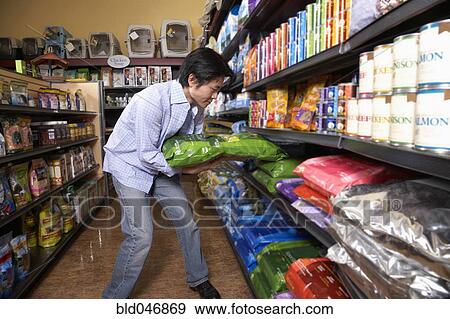 Asian man shopping for pet food View Large Photo Image Stock Photo - Asian man shopping for pet food. Fotosearch