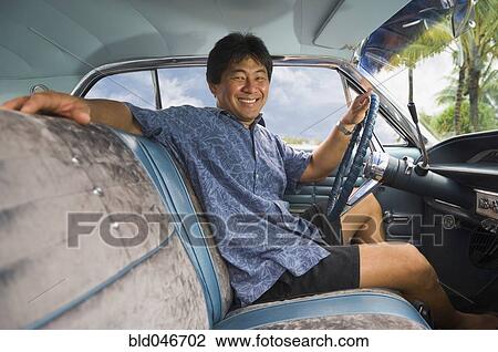 Asian man sitting in car View Large Photo Image Stock Image - Asian man sitting in car. Fotosearch