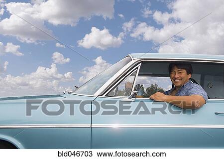 Asian man sitting in car View Large Photo Image Stock Image - Asian man sitting in car. Fotosearch