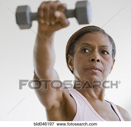 Picture of Senior African American woman lifting weights bld046197 ...