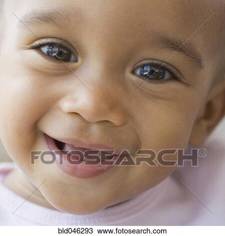 Stock Image - Close up of African American baby smiling. Fotosearch