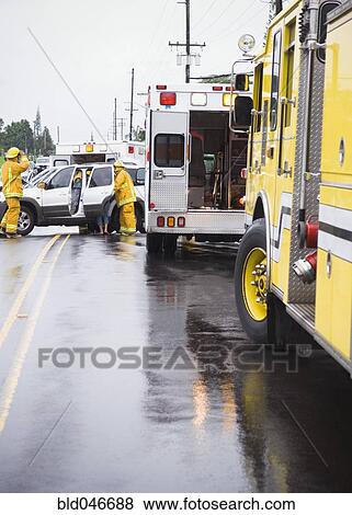 Firefighters at accident scene View Large Photo Image Stock Photo - Firefighters at accident scene. Fotosearch