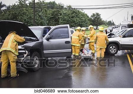 Stock Photo - Firefighters at accident scene. Fotosearch