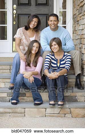 Hispanic family sitting on porch steps View Large Photo Image Stock Photo - Hispanic family sitting on porch steps. Fotosearch