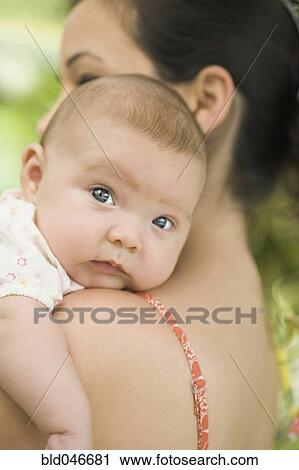 Stock Image - Hispanic mother holding baby. Fotosearch