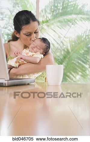 Hispanic mother kissing baby View Large Photo Image Stock Photography - Hispanic mother kissing baby. Fotosearch