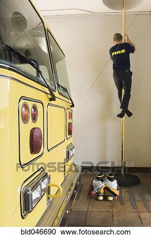 Male firefighter sliding down pole View Large Photo Image Stock Image - Male firefighter sliding down pole. Fotosearch
