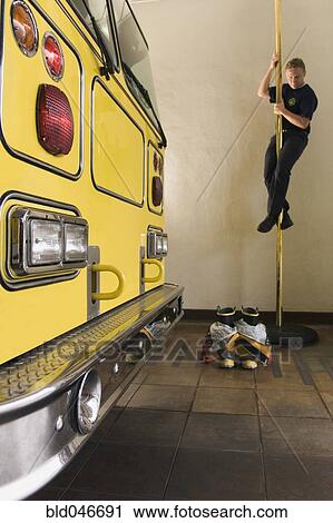 Male firefighter sliding down pole View Large Photo Image Stock Image - Male firefighter sliding down pole. Fotosearch