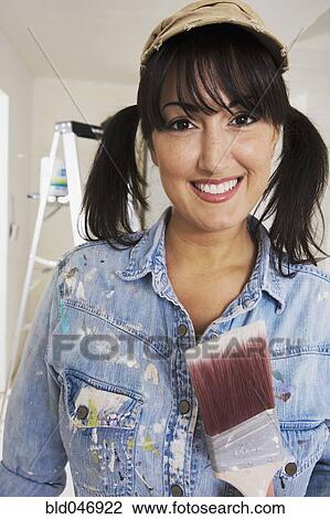 Middle Eastern woman holding paint brush View Large Photo Image Stock Image - Middle Eastern woman holding paint brush. Fotosearch