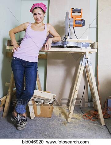 Middle Eastern woman next to table saw View Large Photo Image Stock Image - Middle Eastern woman next to table saw. Fotosearch
