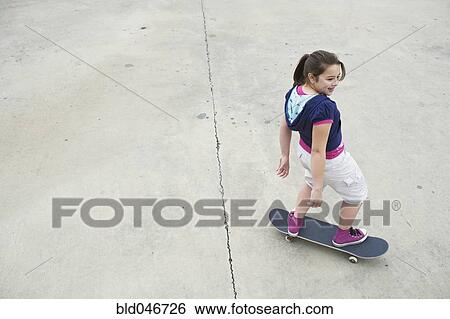 Mixed Race girl riding skateboard View Large Photo Image Stock Photograph - Mixed Race girl riding skateboard. Fotosearch