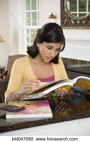 Stock Image - Mixed Race girl studying. Fotosearch
