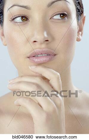 Mixed Race woman with hand on chin View Large Photo Image Stock Image - Mixed Race woman with hand on chin. Fotosearch