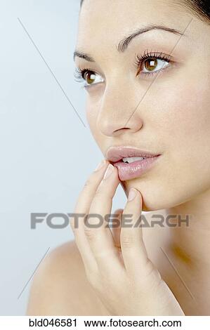 Mixed Race woman with hand on chin View Large Photo Image Stock Image - Mixed Race woman with hand on chin. Fotosearch