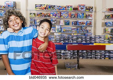 Stock Photography - Multi-ethnic boys hugging. Fotosearch
