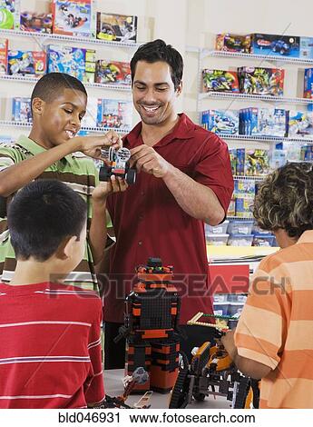Stock Image - Multi-ethnic children playing in toy store. Fotosearch