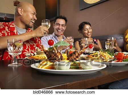 Multi-ethnic friends at restaurant View Large Photo Image Stock Photograph - Multi-ethnic friends at restaurant. Fotosearch