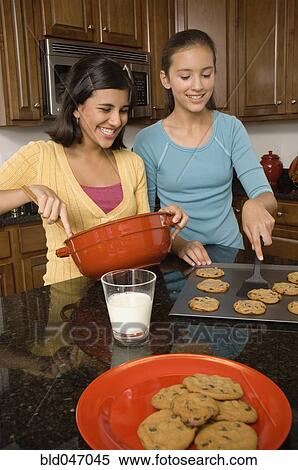 Multi-ethnic girls baking cookies View Large Photo Image Stock Photography - Multi-ethnic girls baking cookies. Fotosearch