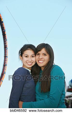 Stock Image - Multi-ethnic girls hugging. Fotosearch