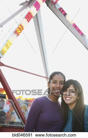 Multi-ethnic girls in front of Ferris wheel View Large Photo Image Stock Image - Multi-ethnic girls in front of Ferris wheel. Fotosearch