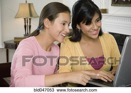 Multi-ethnic girls looking at laptop View Large Photo Image Stock Image - Multi-ethnic girls looking at laptop. Fotosearch